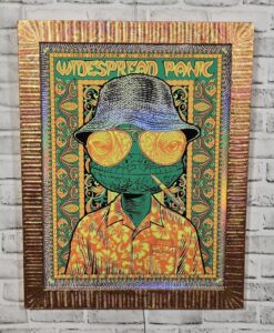 Framed Widespread Panic concert poster for May 8–10, 2026 in Las Vegas, featuring a psychedelic lizard in sunglasses, bucket hat, and floral shirt.